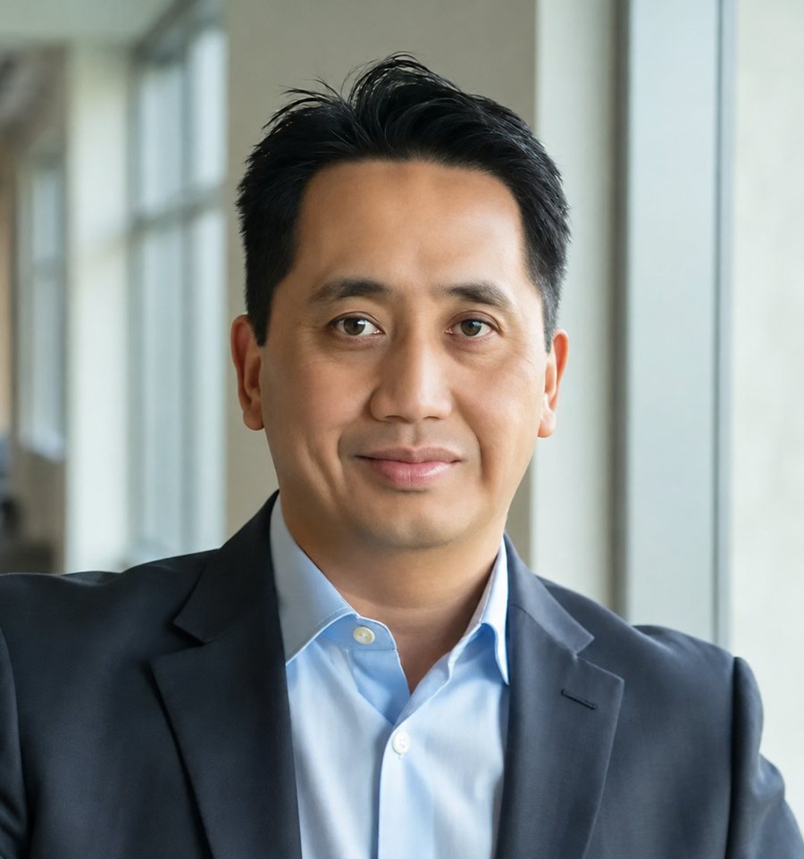 Martin Zialcita, AI Implementation Strategist, in a dark suit jacket and open-collar light blue shirt